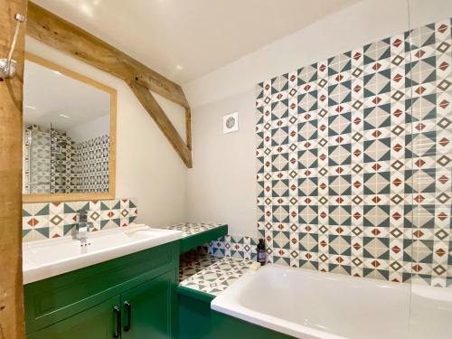 a bathroom with a sink and a mirror at Bushton Barn in Royal Wootton Bassett