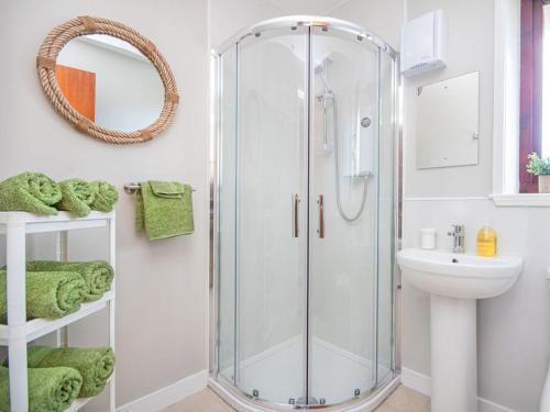 a bathroom with a shower and a sink at Strathy in Dornoch