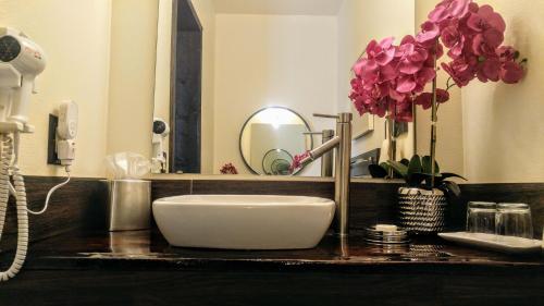 a bathroom counter with a sink and a mirror at The Anniversary Inn - Boise in Boise