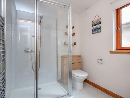 a glass shower in a bathroom with a toilet at The Hive in Dornoch