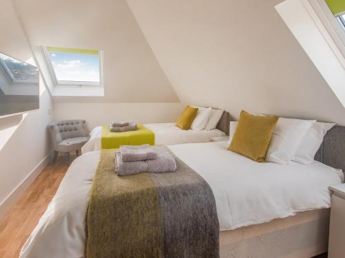 a attic bedroom with two beds and a window at Loft Living - Ukc5413 in Broadstairs