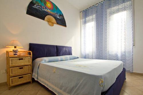 a bedroom with a bed and a dresser and a window at Case vacanze Mirko IMPERIA BORGO MARINA in Imperia