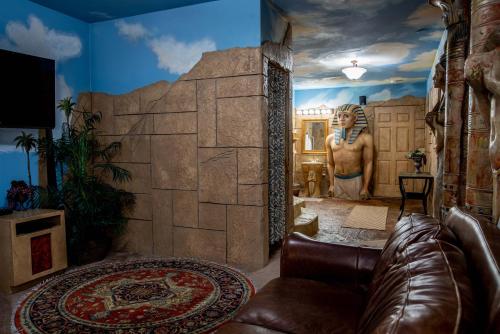 a living room with a mural of a man and a statue at The Anniversary Inn - Boise in Boise