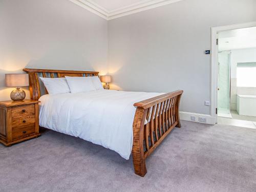 a bedroom with a large bed and a window at Reay House in Nairn