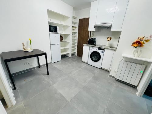 a kitchen with a table and a washing machine at Dream Dwell Paris-two bedrooms apart near Gare du Nord in Paris
