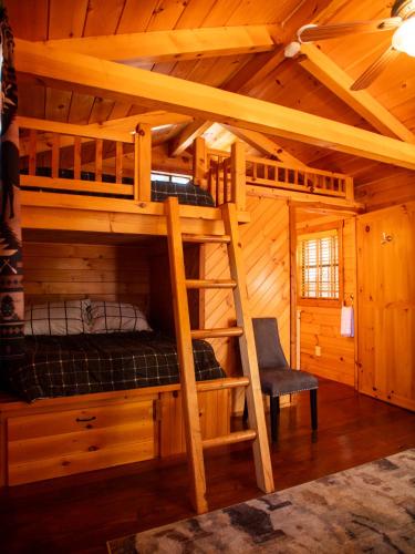 a bedroom with a bunk bed in a wooden cabin at Lakeshore Resort in Lakeshore