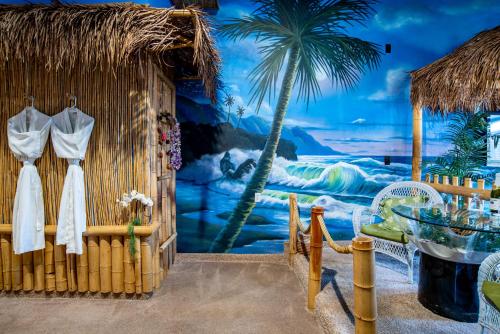 a room with a wall with a painting of a beach at The Anniversary Inn - Boise in Boise