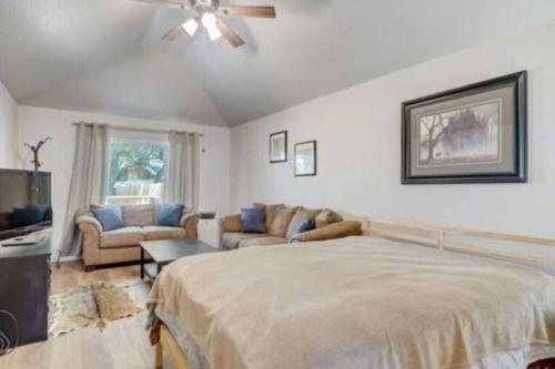 - une chambre avec un lit, des canapés et un ventilateur de plafond dans l'établissement ATV Lakefront Paradise, à Lakehills