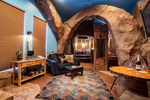 a living room with a large log wall at The Anniversary Inn - Boise in Boise