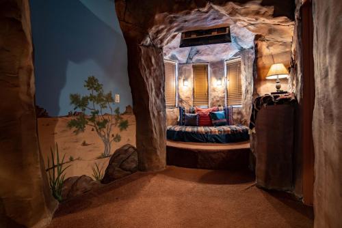 a room with a bed in a rock cave at The Anniversary Inn - Boise in Boise