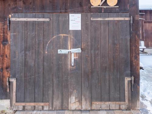a wooden door with a sign on it at Blick auf den Rettenstein Top 2 in Kirchberg in Tirol