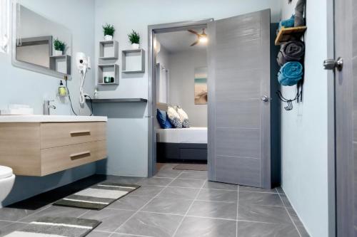 a bathroom with a toilet and a sink at Elleamau in Island Harbour