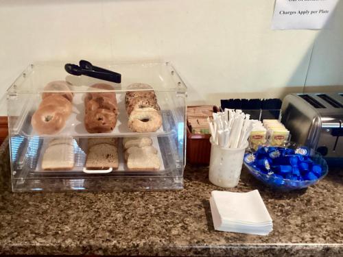 a plastic container filled with different types of donuts on a counter at GreenTree Hotel & Extended Stay I-10 FWY Houston, Channelview, Baytown in Channelview