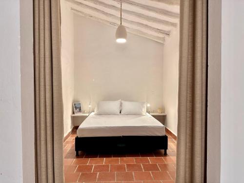 Postel nebo postele na pokoji v ubytování Terracota Loft Barichara