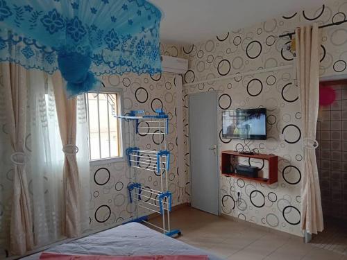 a bedroom with a room with a bed and a window at Partners Residence in Douala