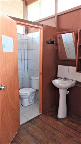 a bathroom with a toilet and a sink at Avatar Amazon Lodge & Canopy Park in Santa Teresa