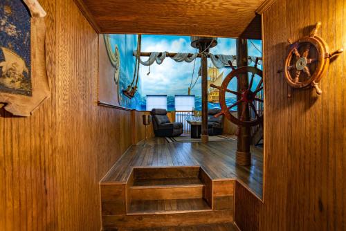 a room with a wooden table in a boat at The Anniversary Inn - Boise in Boise