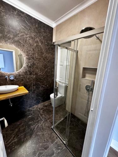 a bathroom with a glass shower and a toilet at Relax and Explore Lisbon Suites and Rooms in Lisbon