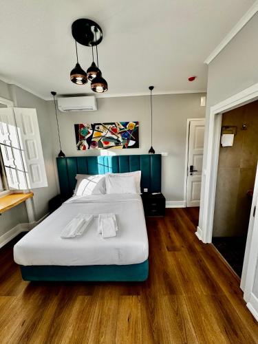 a bedroom with a large bed with a blue headboard at Relax and Explore Lisbon Suites and Rooms in Lisbon