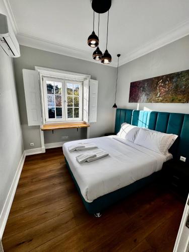 a bedroom with a large bed and a window at Relax and Explore Lisbon Suites and Rooms in Lisbon