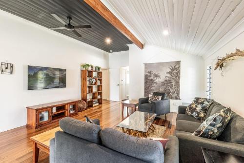 a living room with two couches and a table at High Fives - Pet-Friendly Gem in the Heart of Yamba - Holiday Yamba in Yamba