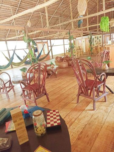 a group of chairs and a table in a room at Avatar Amazon Lodge & Canopy Park in Santa Teresa