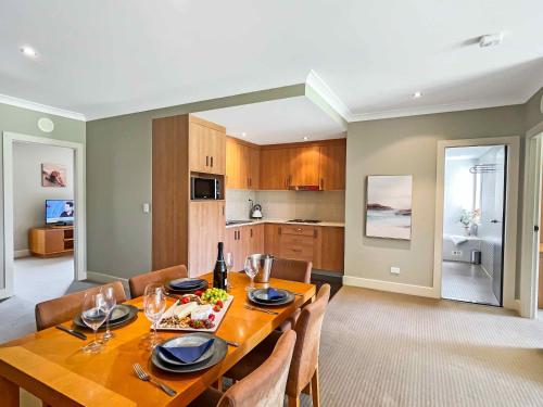 a kitchen and dining room with a table and chairs at Villa Lago in Lovedale