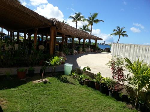a resort with a pavilion with plants and palm trees at Just in paradise in Baie Nettle