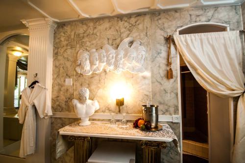 a bathroom with a table with a statue on it at The Anniversary Inn - Logan in Logan
