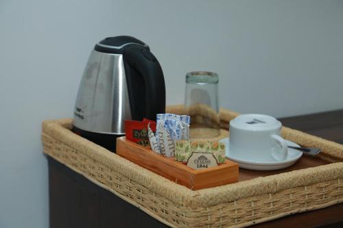 a wicker basket with a coffee maker on a counter at Mzion Hotel Weligama in Weligama