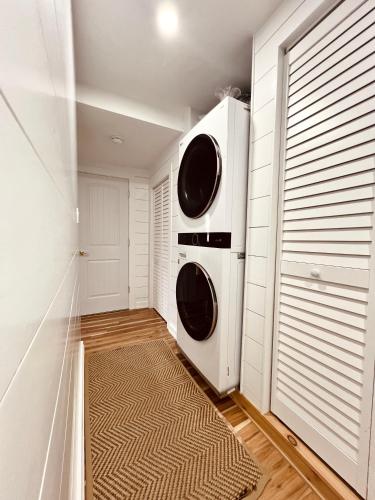 a laundry room with two washers and a rug at Unique Wildwood 3 BR 1,5 BA Entire House in the Heart of Wildwood! in Wildwood