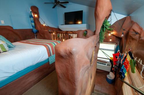 a bedroom with a large statue of a man standing in a bed at The Anniversary Inn - Logan in Logan