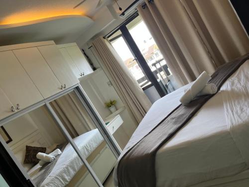 a small bedroom with a bed and a window at 1 Bedroom unit with balcony and facing amenities and just beside SM Ecoland in Davao City