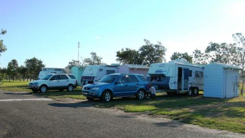 a group of rvs and a car parked in a parking lot at Ingenia Holidays Old Bar Beach in Old Bar