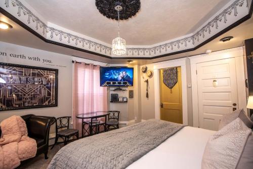 a bedroom with a bed and a table and chairs at The Anniversary Inn - Logan in Logan