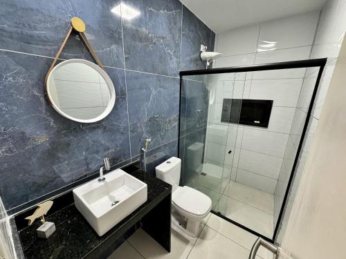 een badkamer met een wastafel, een toilet en een spiegel bij Casa Coroa Grande! A Sua Casa de Praia em São José in São José da Coroa Grande