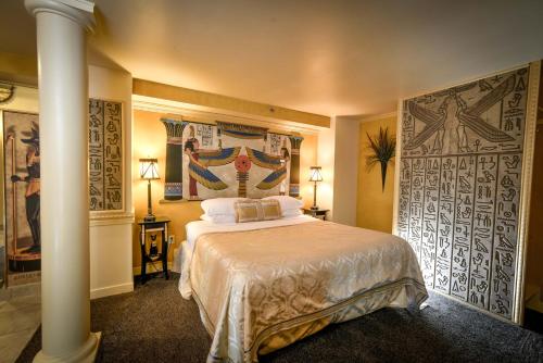 a bedroom with a large bed in a room at The Anniversary Inn - Logan in Logan