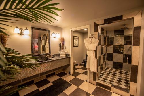 a bathroom with a sink and a shower at The Anniversary Inn - Logan in Logan
