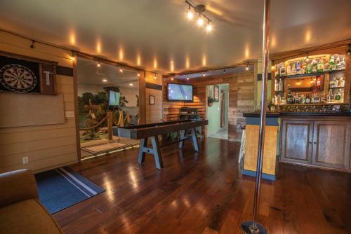 a bar with a ping pong table in a room at The Anniversary Inn - Logan in Logan