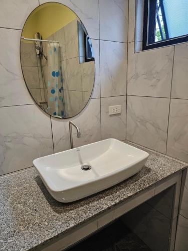 a white sink in a bathroom with a mirror at Pool Villa Baan Sanook Cha-am in Cha Am