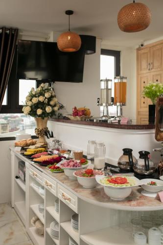 a kitchen counter with bowls of food on it at TrangTrang Premium Hotel & Sky Bar in Hanoi