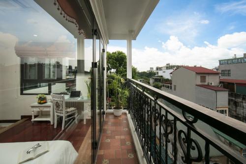 a balcony with a table and a view of a city at TrangTrang Premium Hotel & Sky Bar in Hanoi