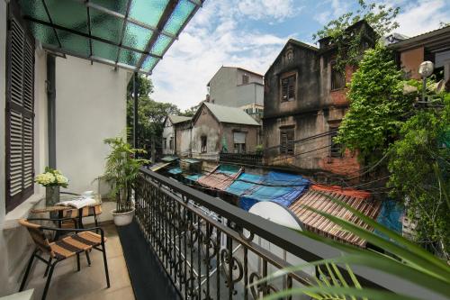 an apartment balcony with a view of a building at TrangTrang Premium Hotel & Sky Bar in Hanoi