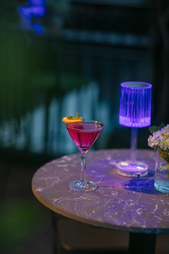 two cocktails sitting on a purple table at TrangTrang Premium Hotel & Sky Bar in Hanoi