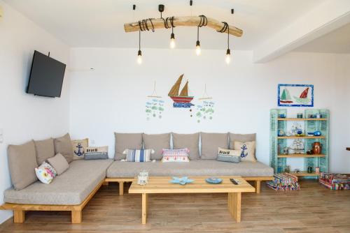 a living room with a couch and a table at Nefeles Arkadiko Chorio in rkadiko Chorio