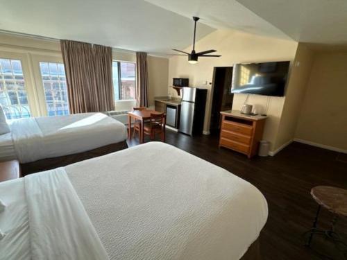 a hotel room with two beds and a kitchen at Clarion Inn in Sierra Vista