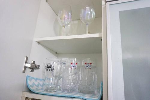 a bunch of wine glasses on a shelf at Gurosien 3 bedroom house in Seoul