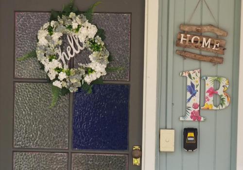a door with a flower wreath on it at JDs Tropical stays in Cairns