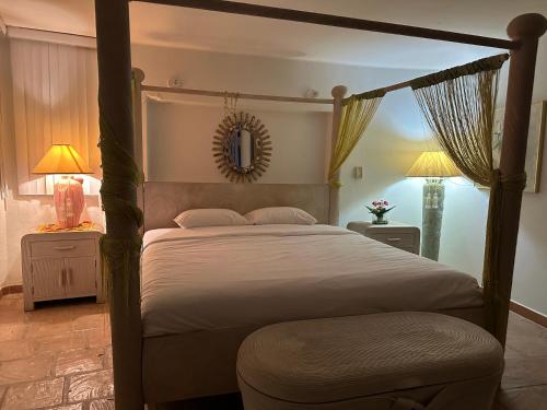 a bedroom with a canopy bed and two lamps at Casa Marrakech VIP in El Agua