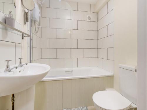 a white bathroom with a sink and a toilet at Brewers Cottage-uk45454 in Montgomery